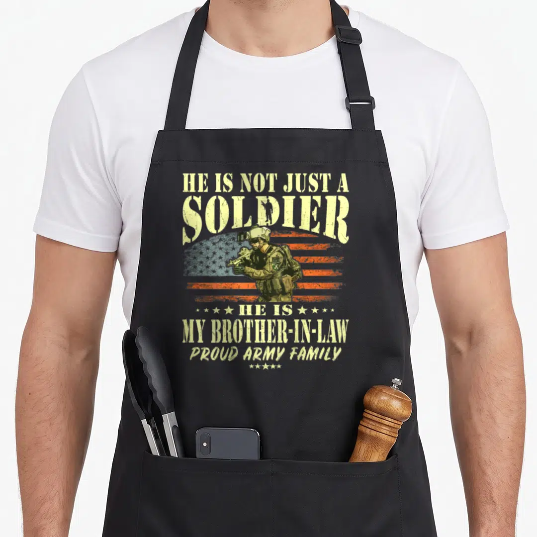 Solider family aprons - Distressed soldier graphic with stacked text HE IS NOT JUST A SOLDIER HE IS MY BROTHER-IN-LAW — shown on a black cotton canvas apron against a white background
