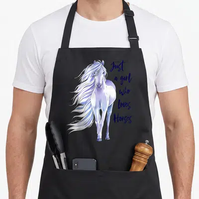 Horse farm apron - Realistic white horse with purple mane and stacked blue text reading Just a girl who loves Horses — shown on a black cotton canvas apron against a white background