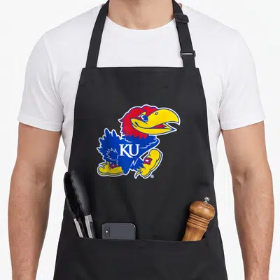 Icon crew apron - Cartoon blue Jayhawk bird with red head yellow beak and boots white KU letters on chest — shown on a black cotton canvas apron against a white background