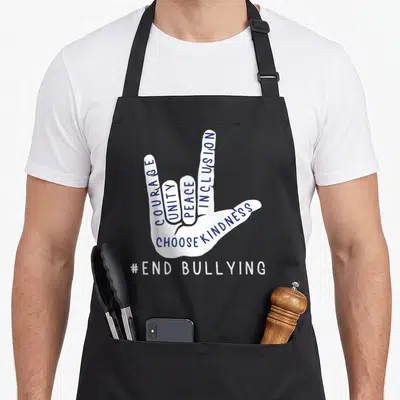 Blue inclusion awareness apron - White hand with blue Courage Unity Peace Inclusion text and End Bullying hashtag — shown on a black cotton canvas apron against a white background