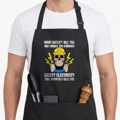 Engineer electricity electrician apron - Skeleton in yellow hard hat and blue overalls holding screwdriver and wire — shown on a black cotton canvas apron against a white background