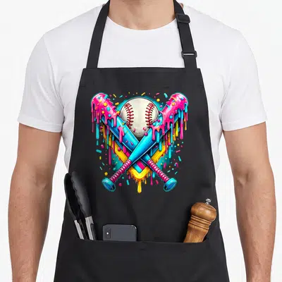 Player drip apron - Cartoon baseball and two crossed bats covered in pink, blue, yellow, and white dripping glaze — shown on a black cotton canvas apron against a white background