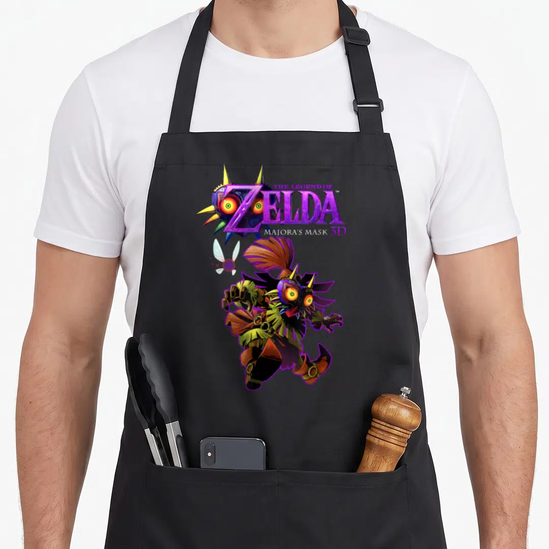 Majoras skull apron - Skull Kid character wearing mask with Tatl fairy and Legend of Zelda Majora's Mask 3D logo — shown on a black cotton canvas apron against a white background