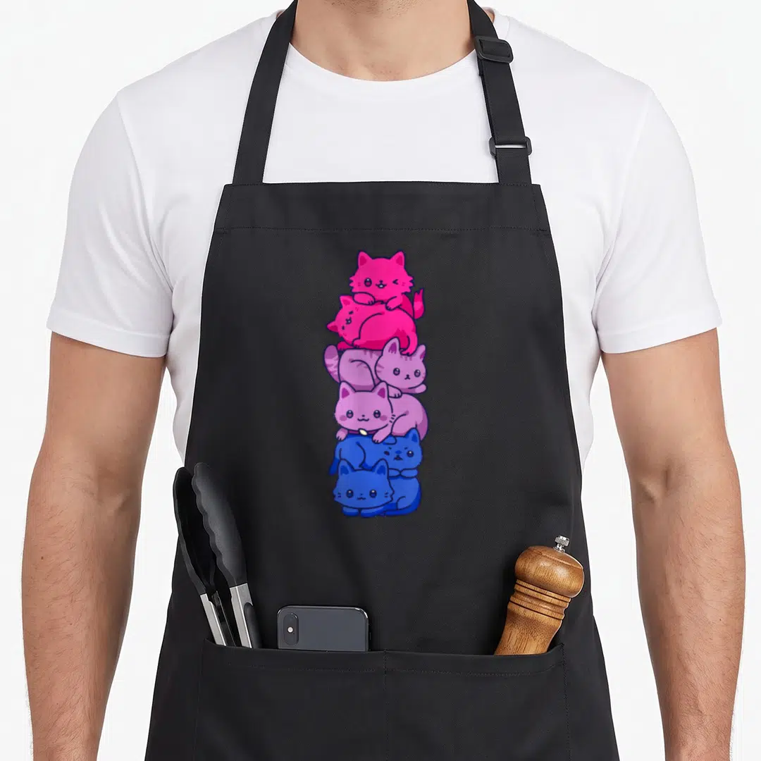 Pride kawaii apron - Six cartoon cats stacked vertically in pink, purple, and blue gradient — shown on a black cotton canvas apron against a white background