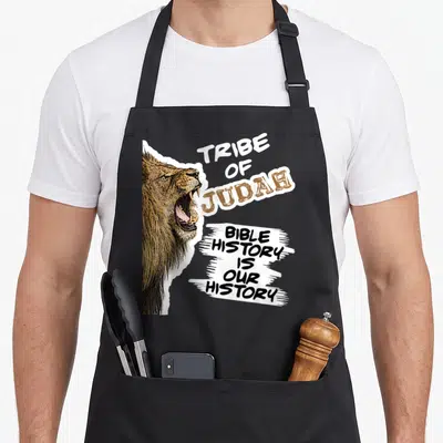 Tribe lion apron - Realistic lion head with Tribe of Judah and Bible History text on white brush strokes — shown on a black cotton canvas apron against a white background