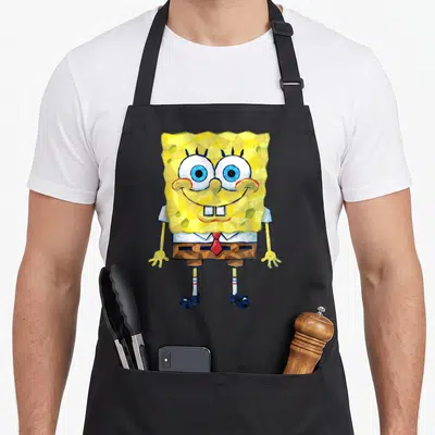 Geometric general apron - Low-poly SpongeBob SquarePants illustration with faceted yellow body and red tie — shown on a black cotton canvas apron against a white background