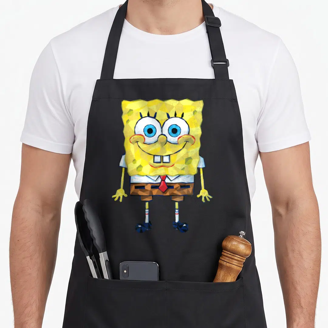 Geometric general apron - Low-poly SpongeBob SquarePants illustration with faceted yellow body and red tie — shown on a black cotton canvas apron against a white background