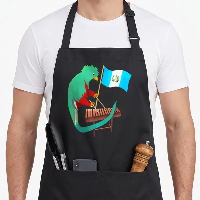 Guatemala marimba apron - Cartoon parrot holding flag and mallets next to a brown xylophone — shown on a black cotton canvas apron against a white background