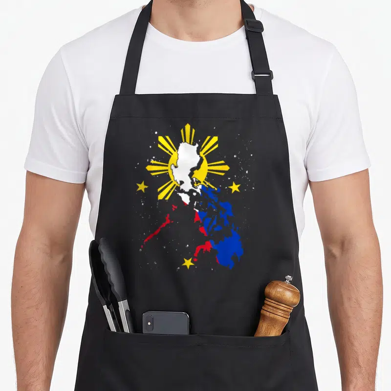 Heritage pride apron - Map of Philippines filled with blue red white and yellow flag colors surrounded by a yellow sun — shown on a black cotton canvas apron against a white background
