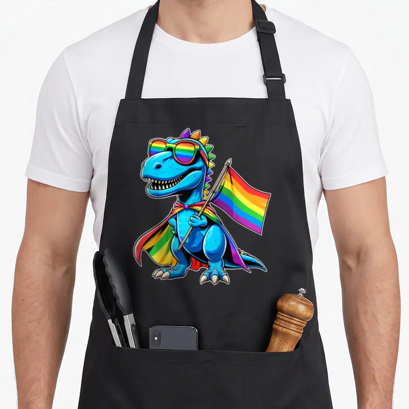 Gay dinosaur apron - Blue cartoon dinosaur wearing rainbow sunglasses and cape holding a rainbow flag on a pole — shown on a black cotton canvas apron against a white background