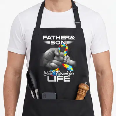 Autism father son apron - Fist bump photo over colorful puzzle ribbon with FATHER& SON and Best Friends for LIFE text — shown on a black cotton canvas apron against a white background