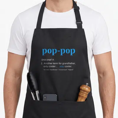 Cute pop father day apron - Blue and white dictionary style text defining pop-pop as another term for grandfather — shown on a black cotton canvas apron against a white background