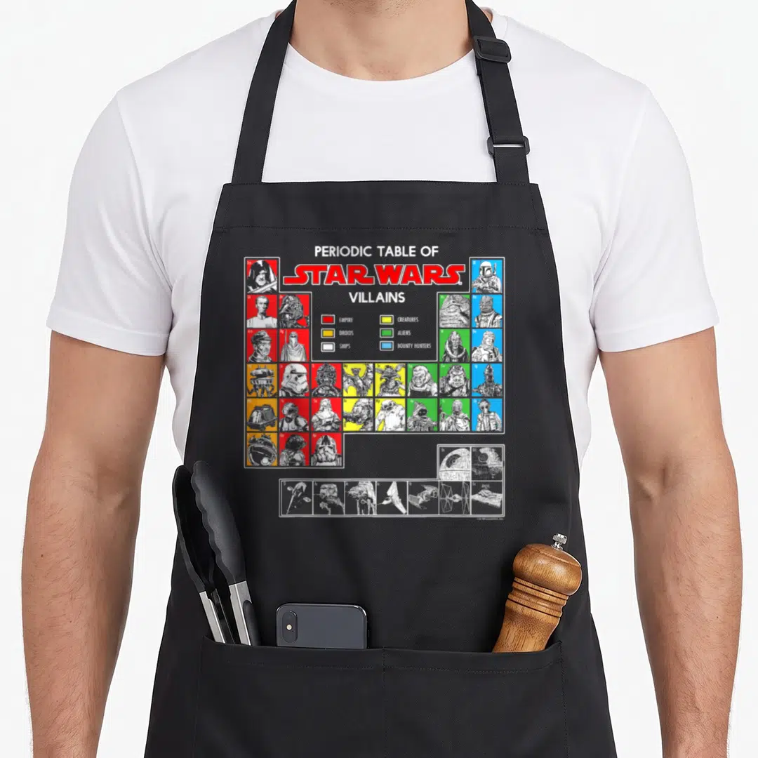 Vintage periodic table apron - Star Wars villains grid with colored squares for empire, droids, creatures, aliens — shown on a black cotton canvas apron against a white background