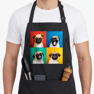 Portrait dog apron - Four square panels of pug faces on red blue green and yellow backgrounds — shown on a black cotton canvas apron against a white background