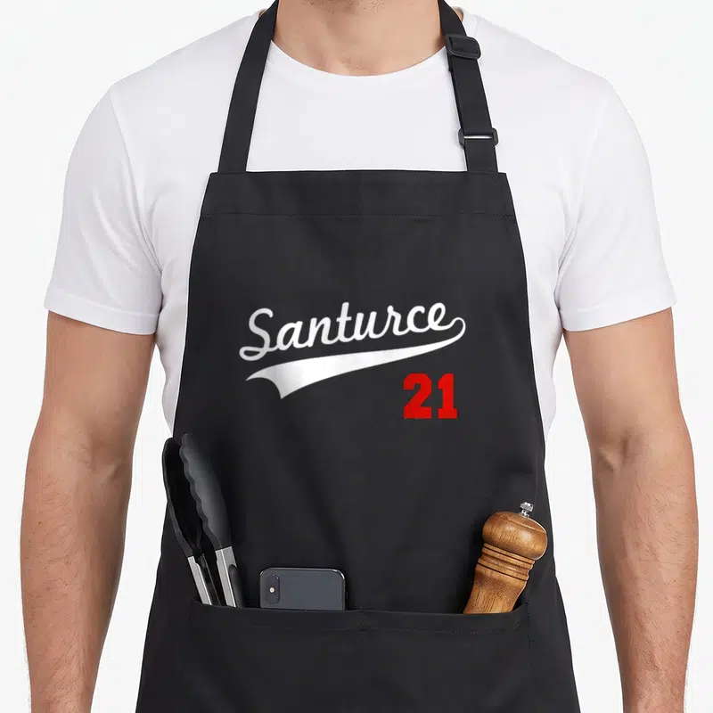 Puerto baseball apron - White Santurce script over white swoosh with red 21 number below — shown on a black cotton canvas apron against a white background