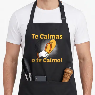 Mother spanish aprons - Orange flip flop held by hand with Te Calmas text over white dots — shown on a black cotton canvas apron against a white background