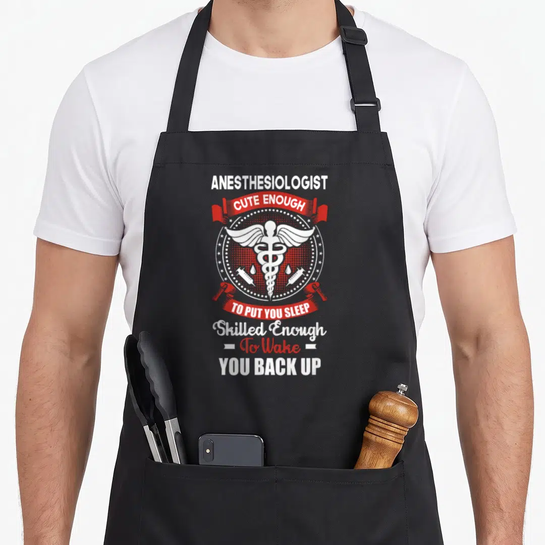 Anesthesiologist doctor apron - White and red typography with caduceus and two syringes on black apron — shown on a black cotton canvas apron against a white background
