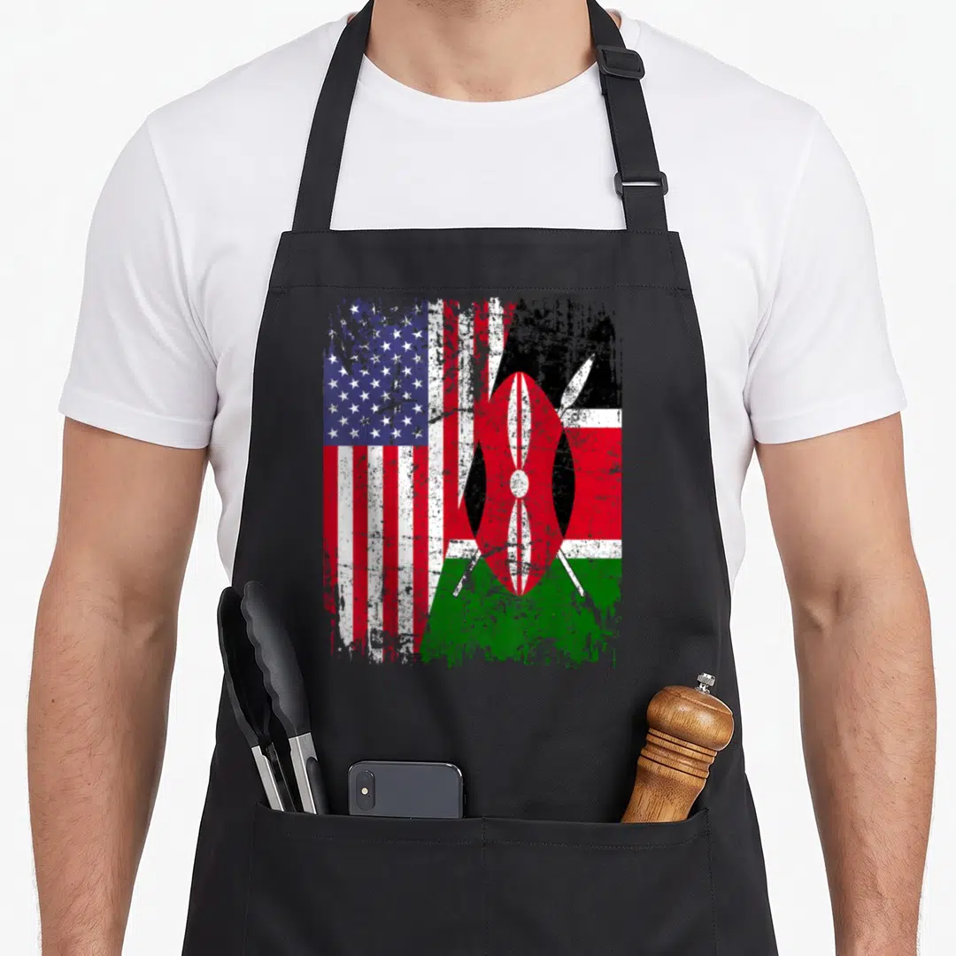 Kenyan american flag apron - Merged weathered US and Kenyan flags with shield and spears in red white blue black — shown on a black cotton canvas apron against a white background