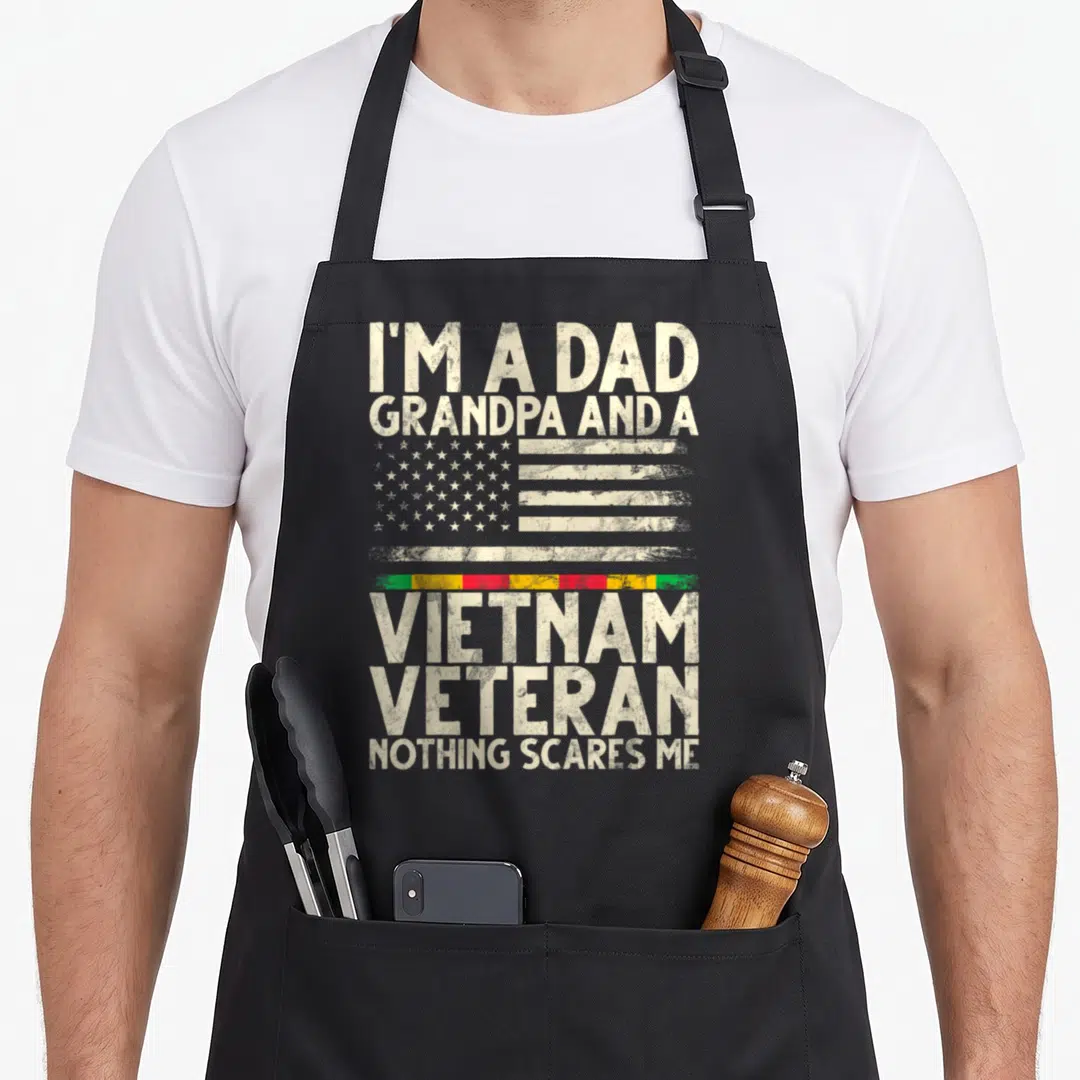 Vietnam grandpa apron - Distressed US flag and stacked text reading I'm a Dad Grandpa Vietnam Veteran Nothing Scares Me — shown on a black cotton canvas apron against a white background