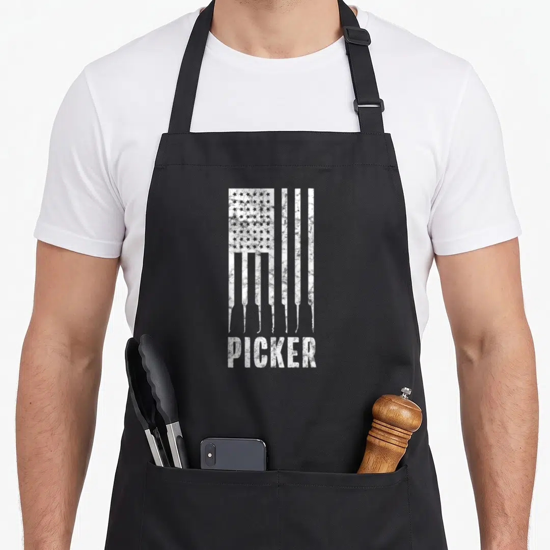 Lock american flag apron - Distressed white USA flag formed by lock pick shapes above the word PICKER — shown on a black cotton canvas apron against a white background