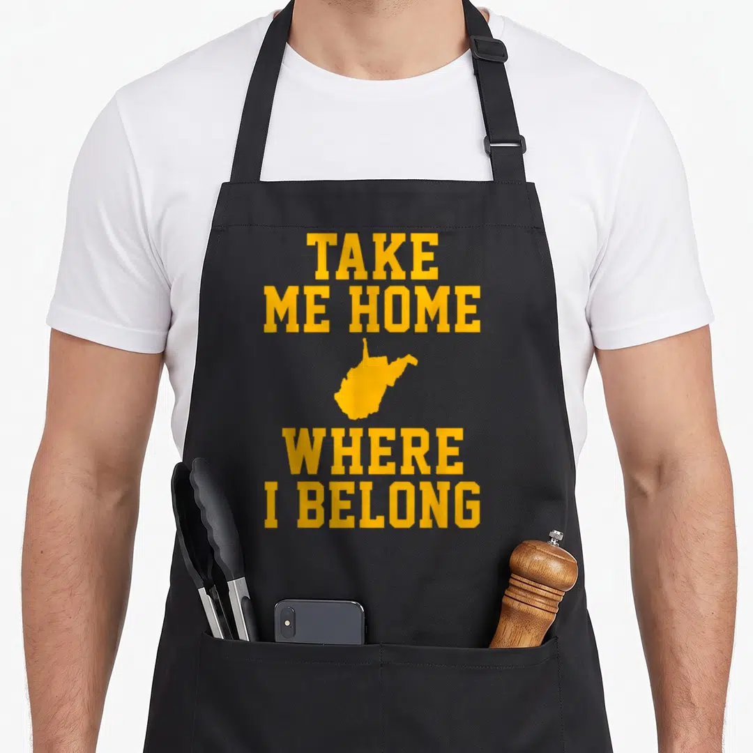 Mountain morgantown apron - Yellow TAKE ME HOME WHERE I BELONG text with a West Virginia state silhouette stacked — shown on a black cotton canvas apron against a white background