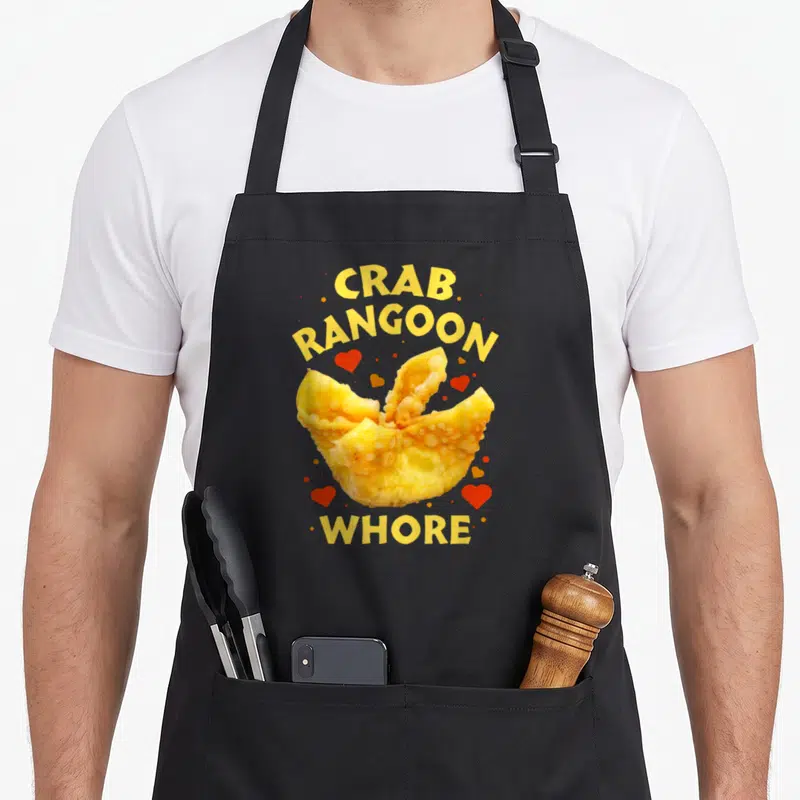 Funny rangoon crab apron - Cartoon crab rangoon surrounded by red hearts with yellow text CRAB RANGOON WHORE — shown on a black cotton canvas apron against a white background