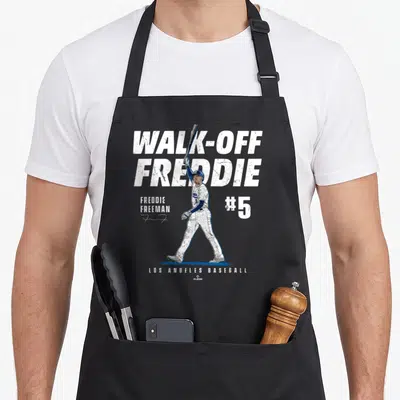 Walk baseball apron - Player holding bat aloft with WALK-OFF FREDDIE FREEMAN #5 text in white and blue — shown on a black cotton canvas apron against a white background