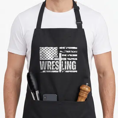 Wrestling patriotic aprons - Distressed white USA flag, centered cross, and WRESTLING text on black fabric — shown on a black cotton canvas apron against a white background