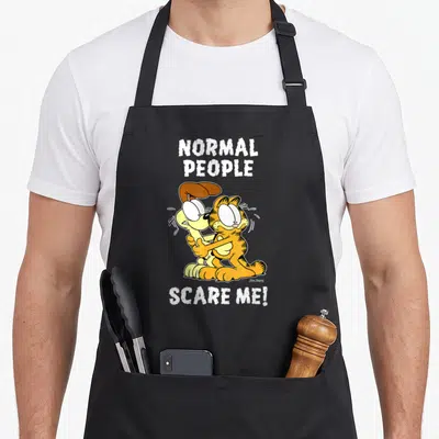 Scare cat apron - Garfield hugging Odie with Normal People Scare Me text in orange and white — shown on a black cotton canvas apron against a white background