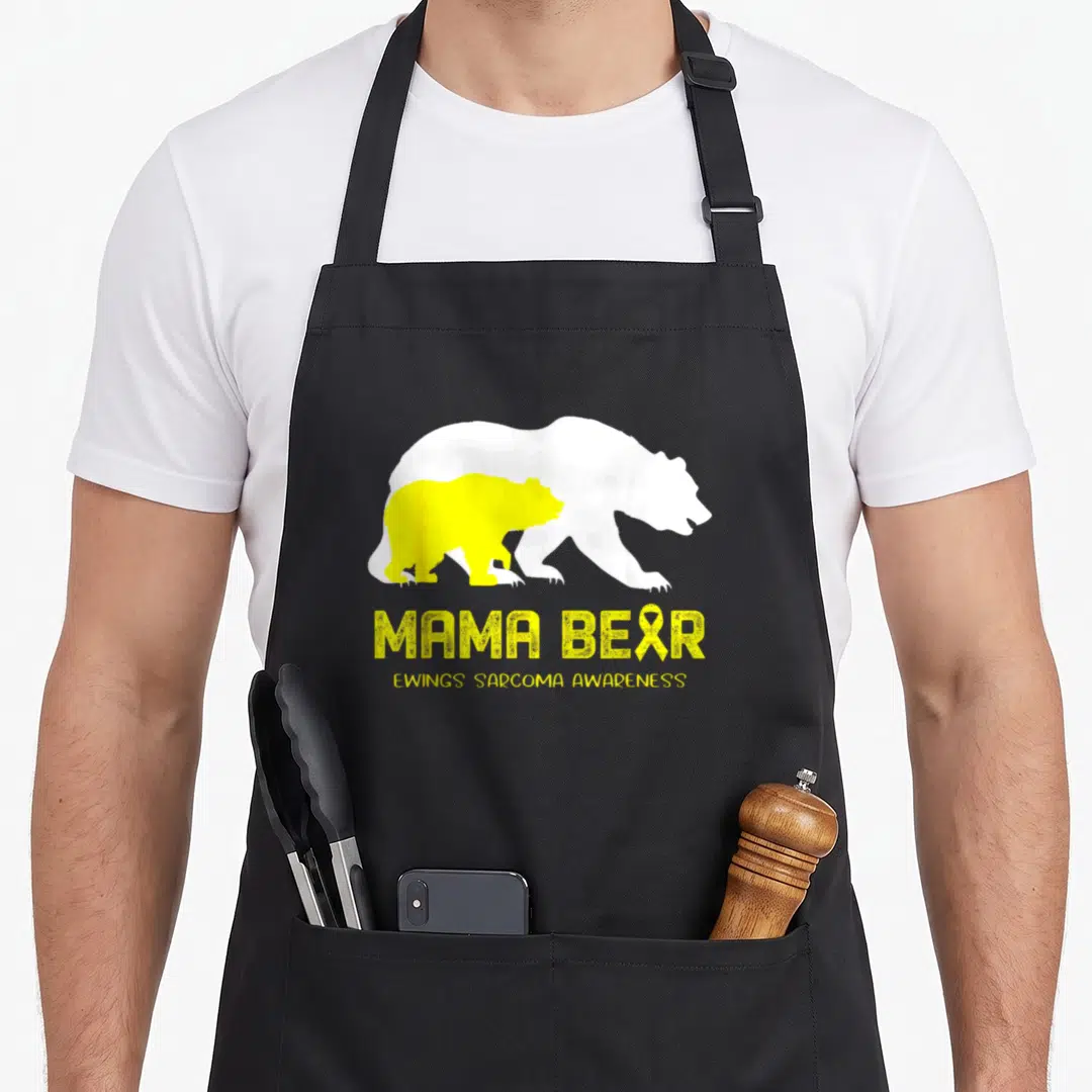 Ewing mama bear apron - White and yellow bear silhouettes with MAMA BEAR text and ribbon on black background — shown on a black cotton canvas apron against a white background