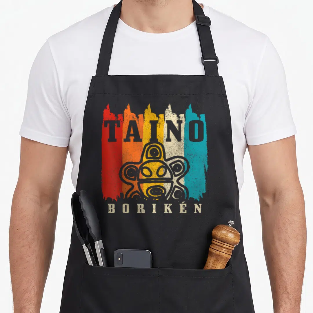 Boriken tandoori apron - TAINO BORIKEN petroglyph over red orange yellow beige blue brush strokes — shown on a black cotton canvas apron against a white background