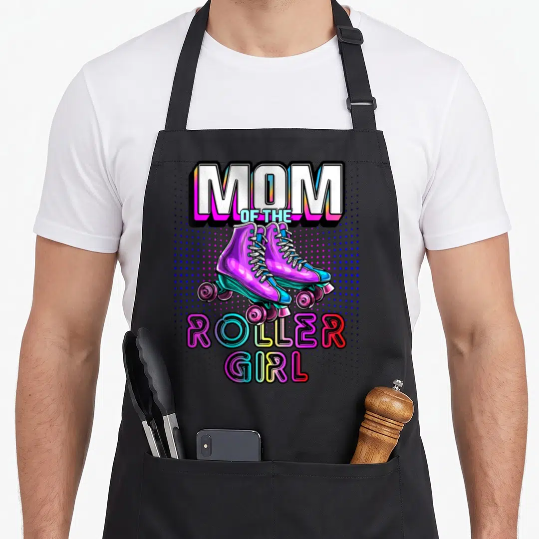 Roller family aprons - MOM OF THE ROLLER GIRL text above purple roller skates on blue halftone background — shown on a black cotton canvas apron against a white background