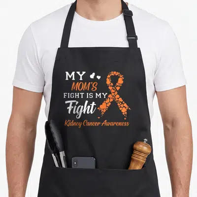 Fight kidney disease awareness apron - Stacked white and orange text next to an awareness ribbon constructed — shown on a black cotton canvas apron against a white background