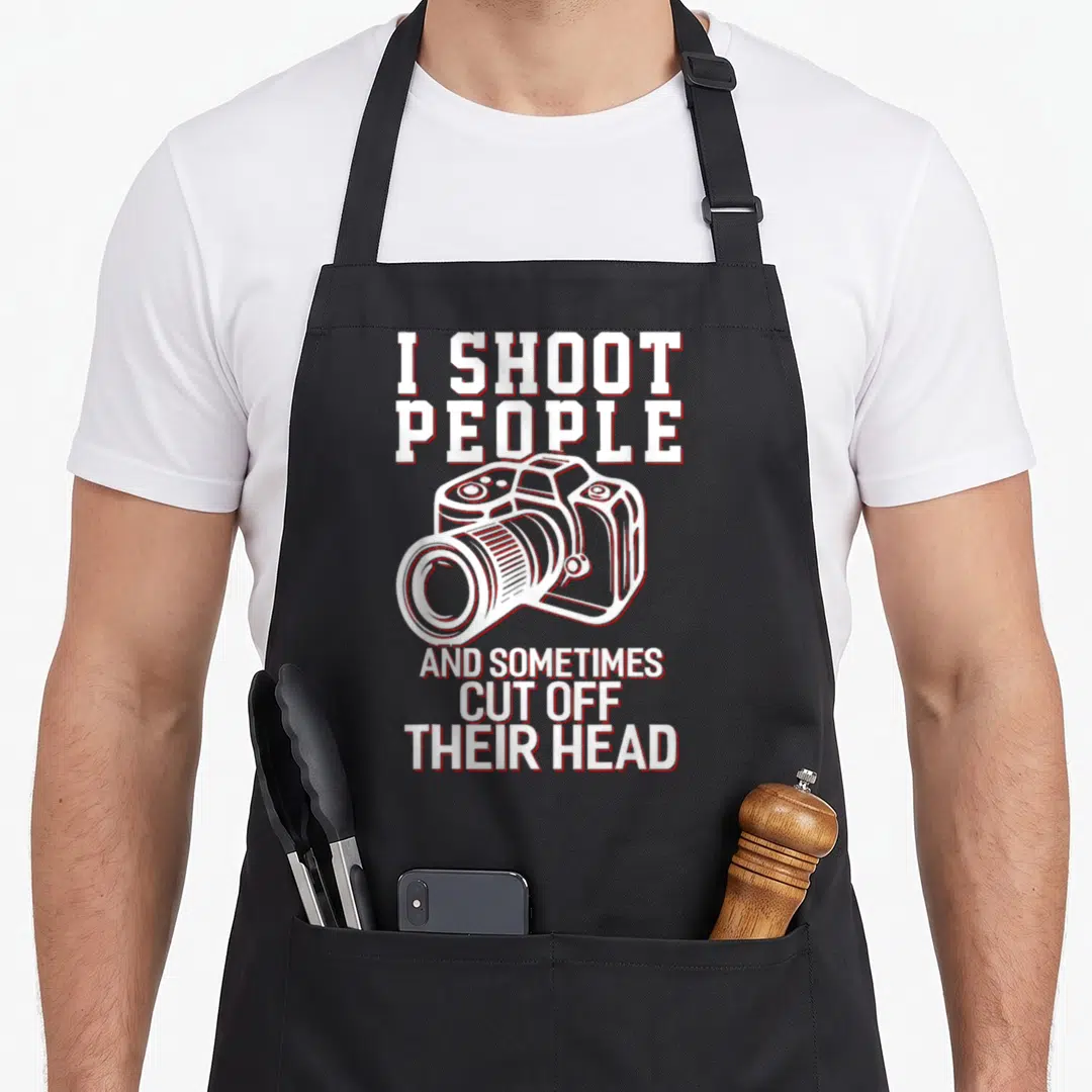 Shoot photography apron - I Shoot People text and camera outline in white with red borders — shown on a black cotton canvas apron against a white background