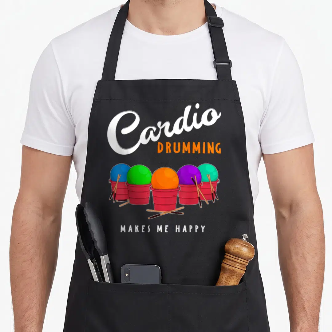 Cardio online squad apron - Five red buckets with colored balls and drumsticks under Cardio Drumming Makes Me Happy text — shown on a black cotton canvas apron against a white background