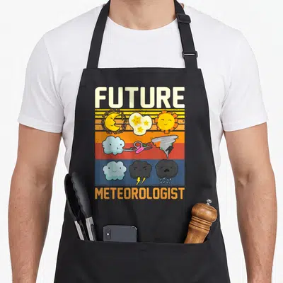 Youth meteorologist apron - Future Meteorologist text with cartoon sun, tornado, and rain clouds on stripes — shown on a black cotton canvas apron against a white background