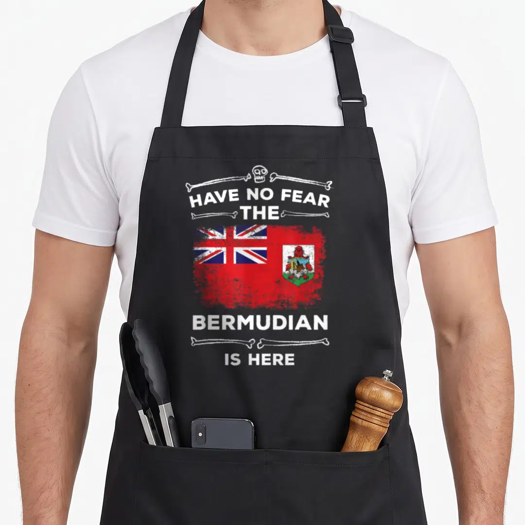 Fear halloween apron - Bermuda flag in red white and blue with skull crossbones and text Have No Fear The Bermudian Is — shown on a black cotton canvas apron against a white background