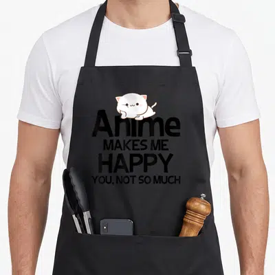 Funny much anime apron - White cartoon cat sitting on stacked black text reading Anime Makes Me Happy You Not So Much — shown on a black cotton canvas apron against a white background