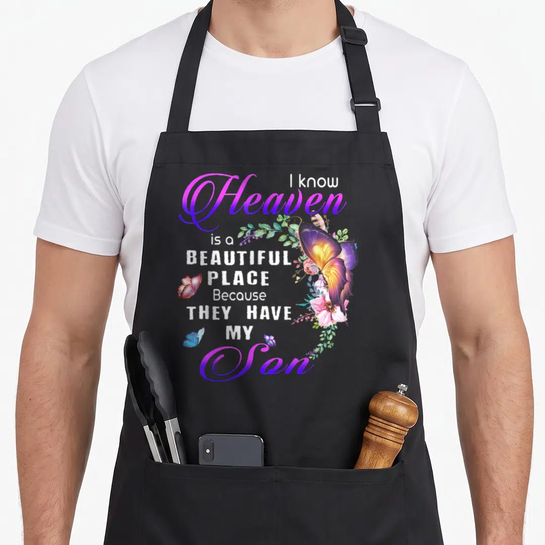 Heaven beautiful apron - Butterfly and floral art with text I know heaven is a beautiful place because they have my son — shown on a black cotton canvas apron against a white background