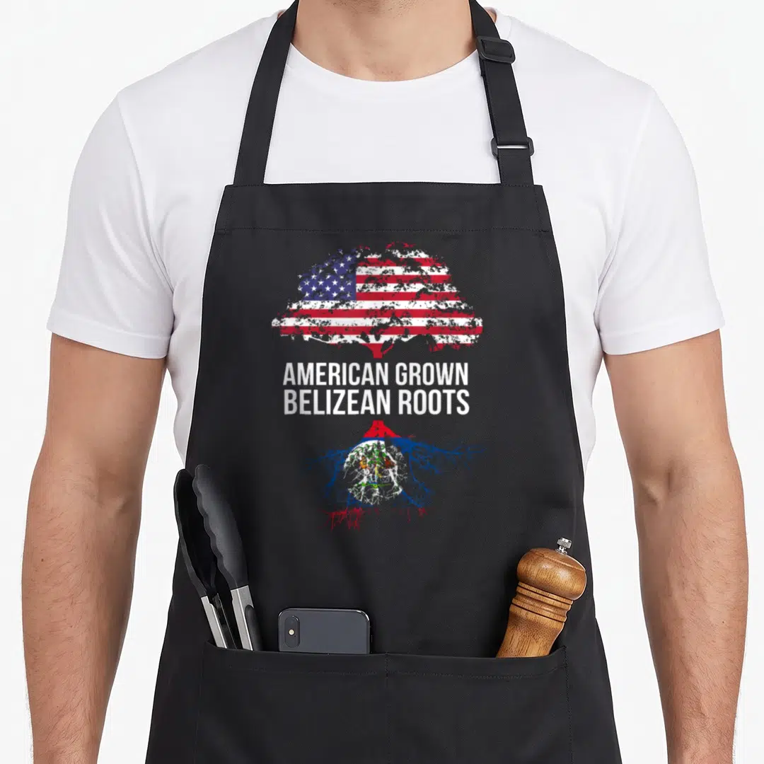 Grown belizean apron - Tree with US flag canopy red trunk and Belize flag roots white text distressed — shown on a black cotton canvas apron against a white background