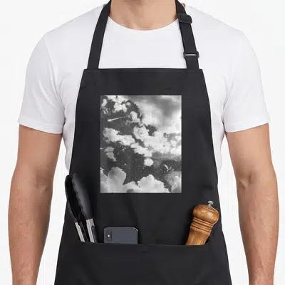 Indie vaporwave goth apron - Grainy black and white starry night sky photo with clouds and crescent moon reflection — shown on a black cotton canvas apron against a white background