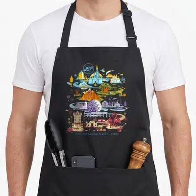 Walt crazy mouse man apron - Circular Disney World landmark collage with 1971 date and most magical place text — shown on a black cotton canvas apron against a white background