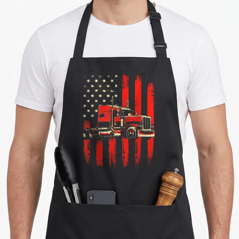 Driver trucking semi truck apron - Red and white semi-truck silhouette on distressed American flag pattern — shown on a black cotton canvas apron against a white background