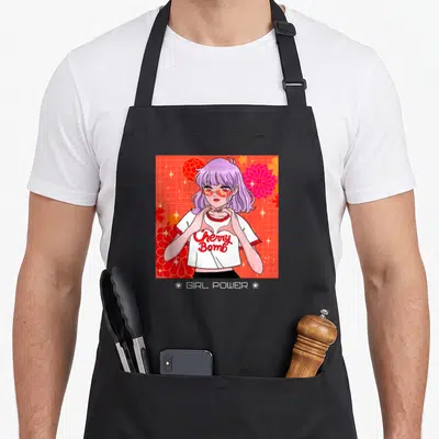 Power anime apron - Purple haired woman making heart hands with Cherry Bomb and GIRL POWER text on red grid — shown on a black cotton canvas apron against a white background