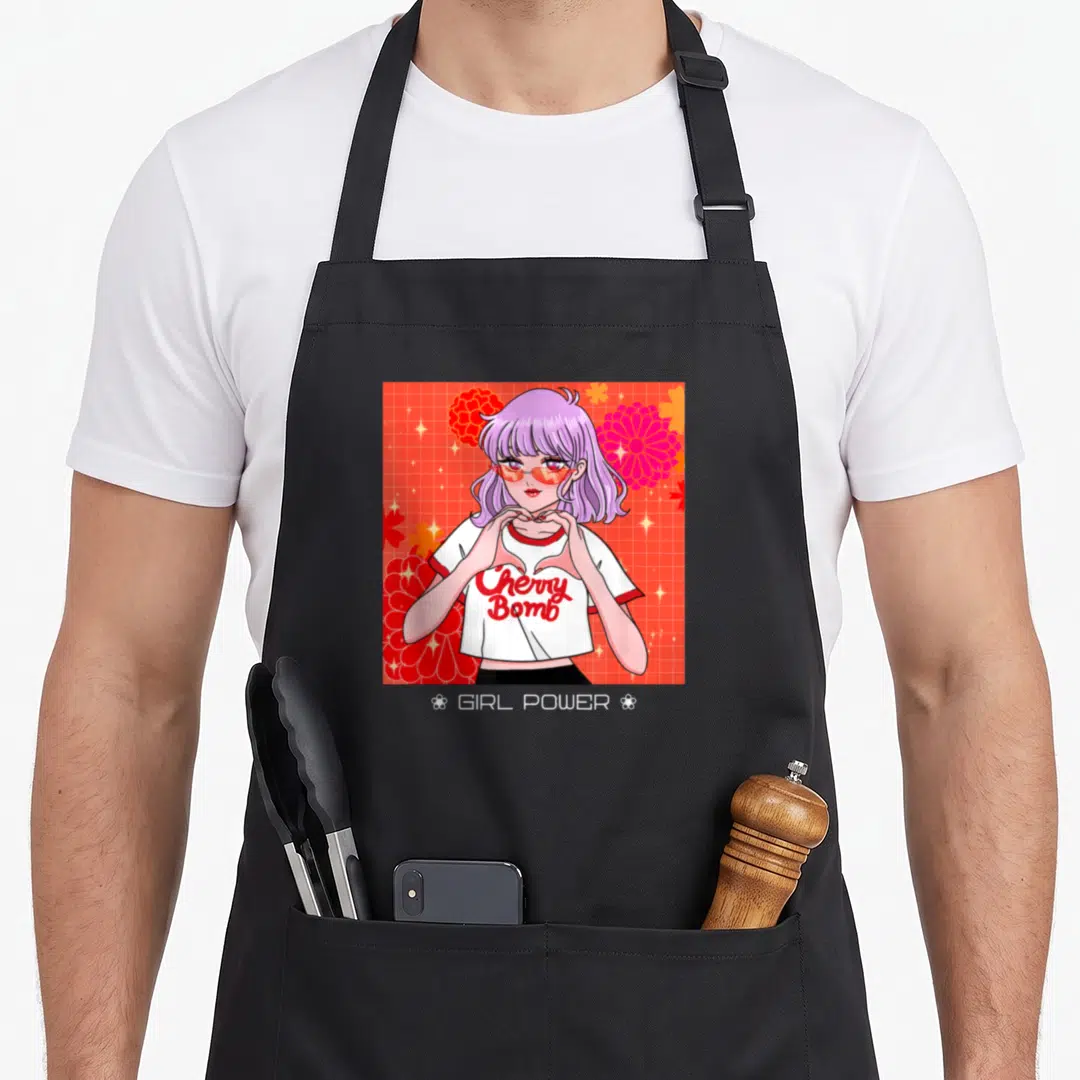 Power anime apron - Purple haired woman making heart hands with Cherry Bomb and GIRL POWER text on red grid — shown on a black cotton canvas apron against a white background