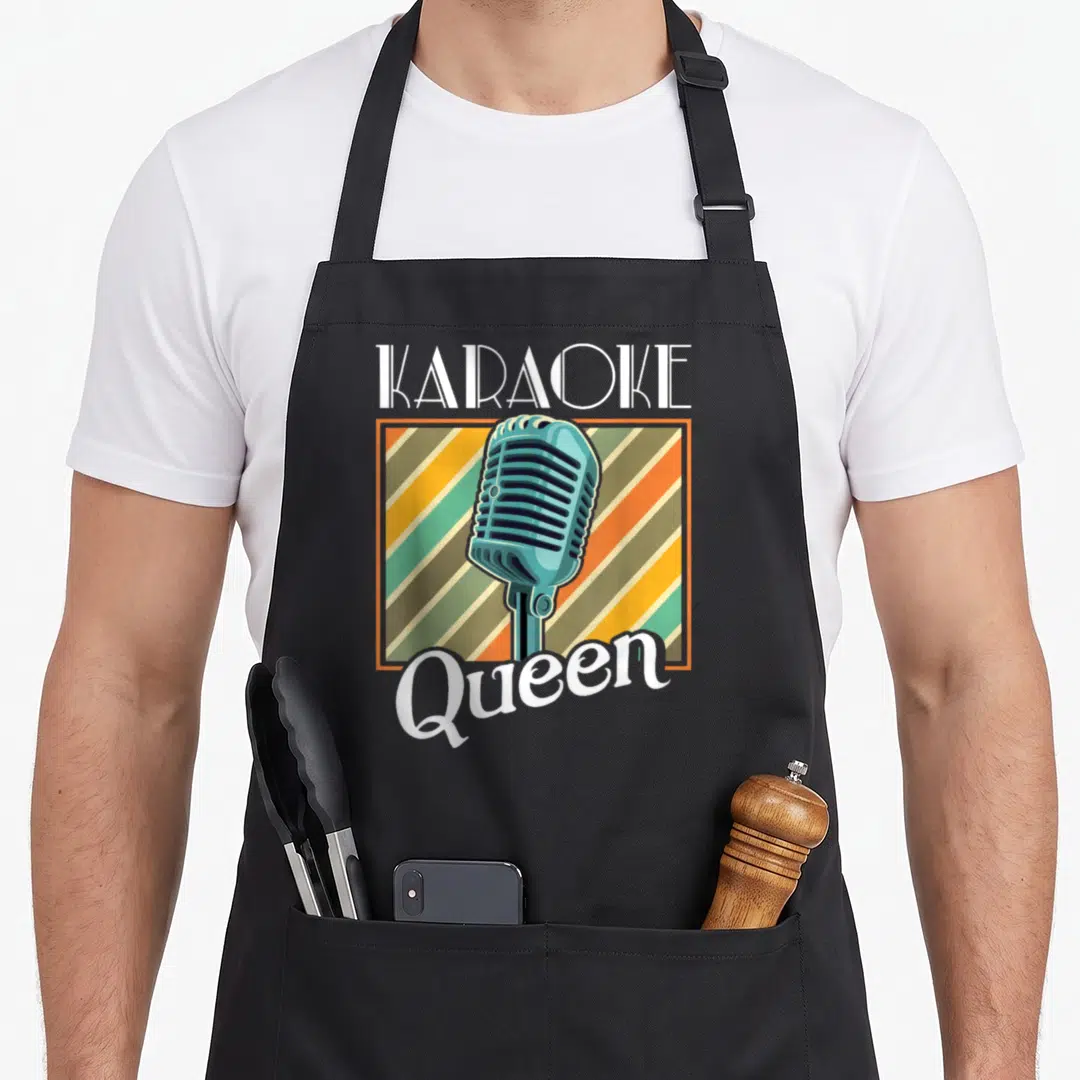 Karaoke queen apron - Retro teal microphone on striped background with KARAOKE Queen text — shown on a black cotton canvas apron against a white background