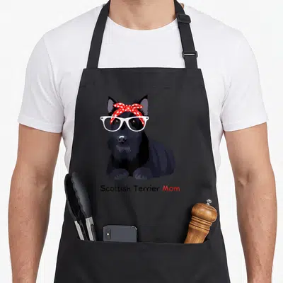 Scottie dog apron - Cartoon black Scottie dog with white glasses and red polka dot bandana — shown on a black cotton canvas apron against a white background