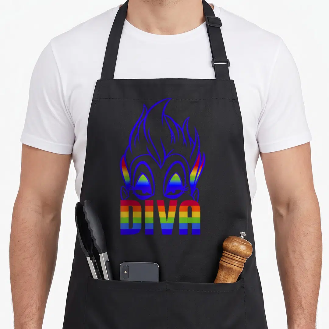Villain rainbow apron - Cartoon face with rainbow eyes and hair, DIVA text in rainbow stripes, blue outlines — shown on a black cotton canvas apron against a white background