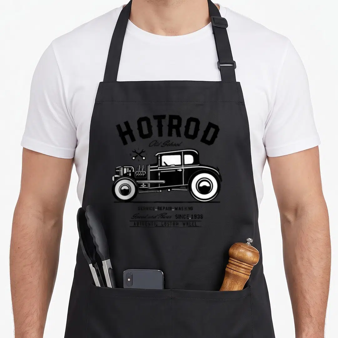 School hot rod apron - Black and white hot rod car with crossed wrenches and service repair washing text — shown on a black cotton canvas apron against a white background