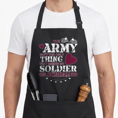 Scream wife apron - Stacked maroon and white text with two crossed flags, hearts, and six stars in distressed style — shown on a black cotton canvas apron against a white background